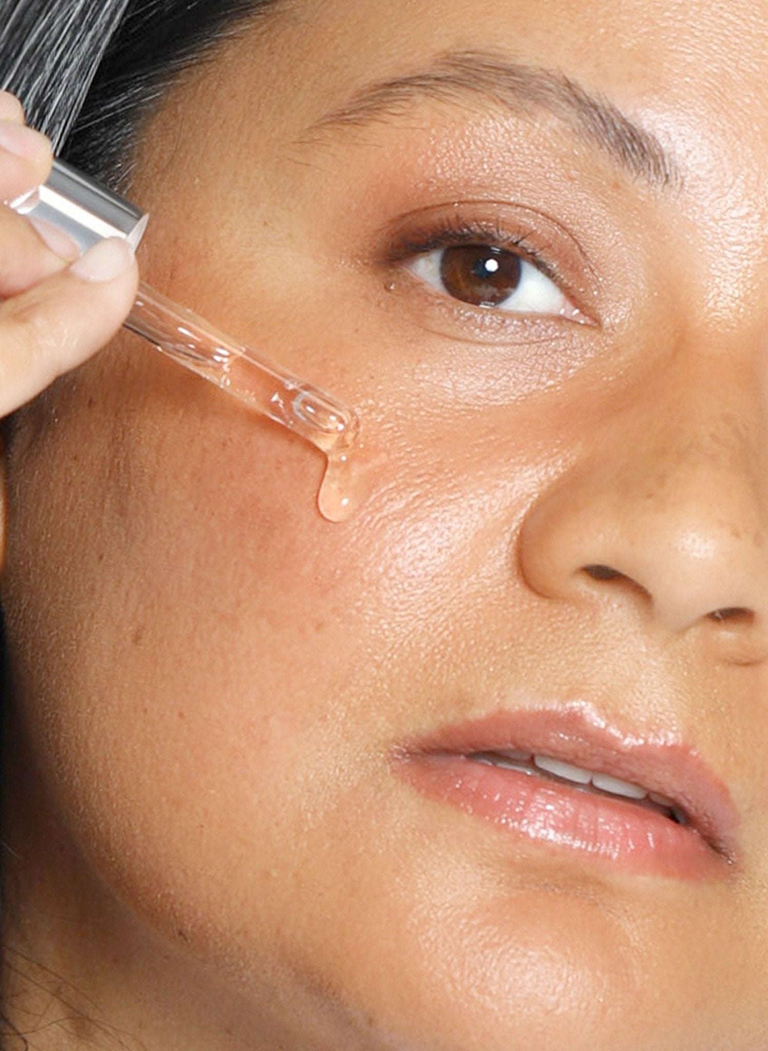 Theorem Serum Boost gliding across skin on application.