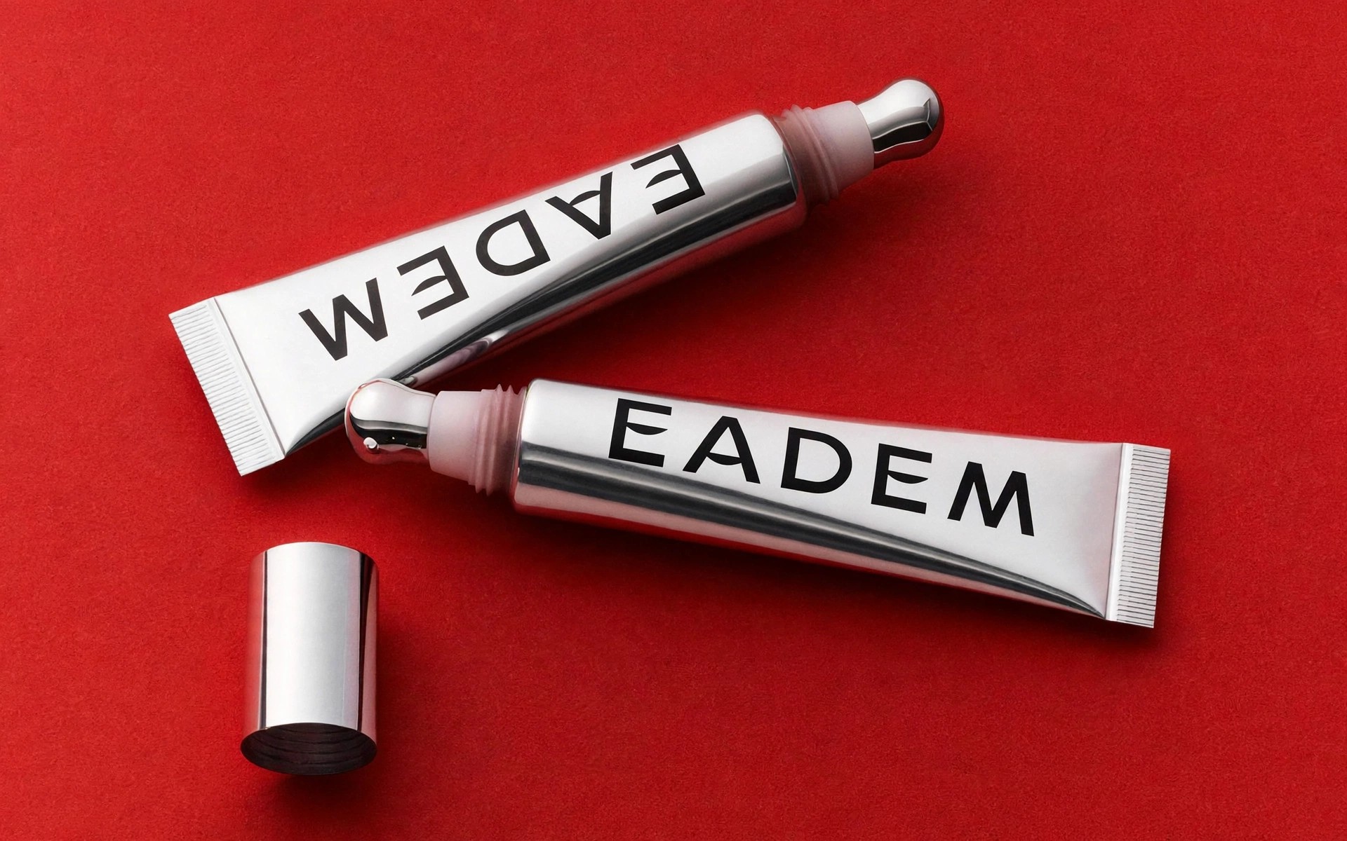 Eadem lip products displayed on red background.