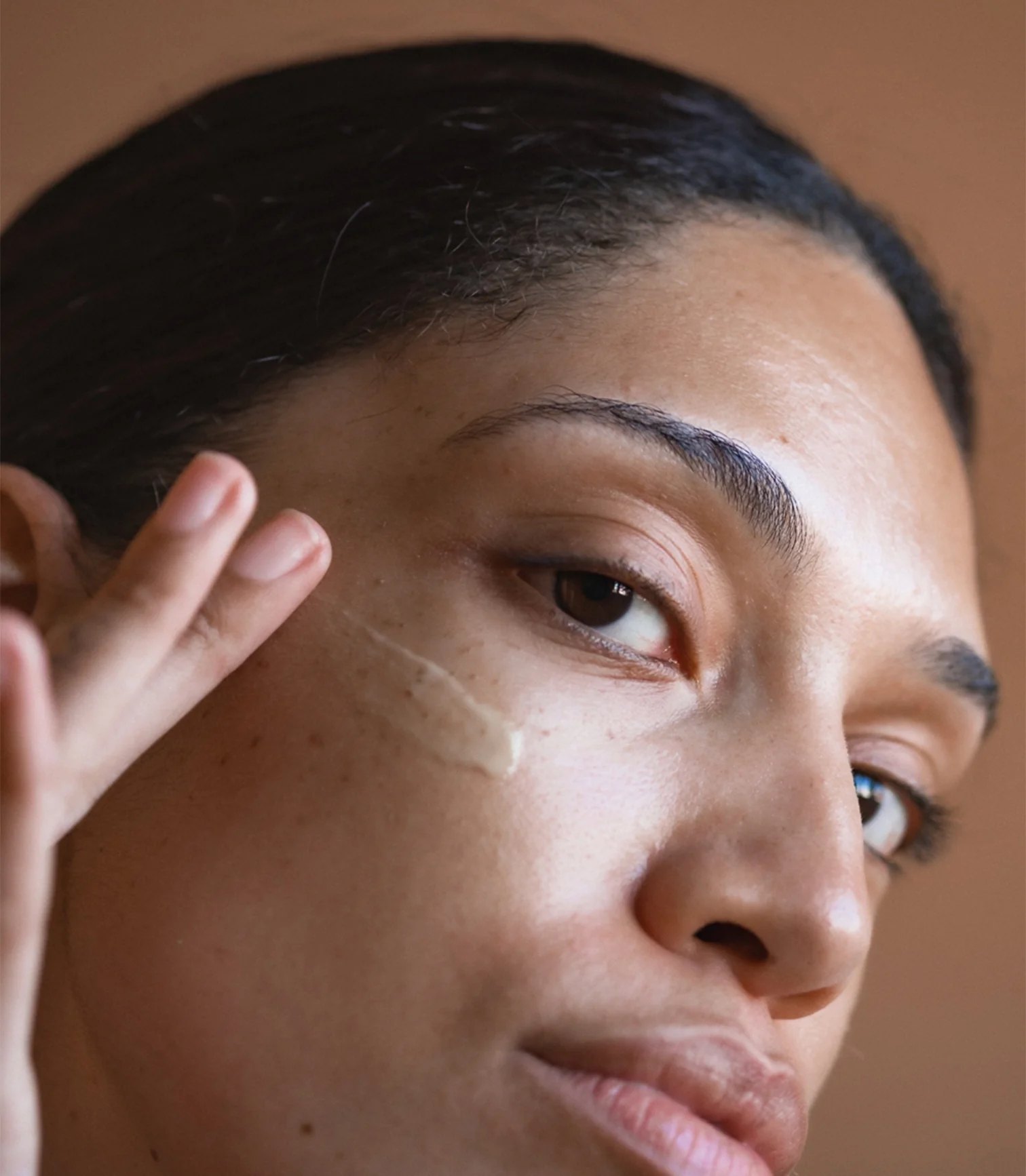 Close view of balm texture applied near the eye.