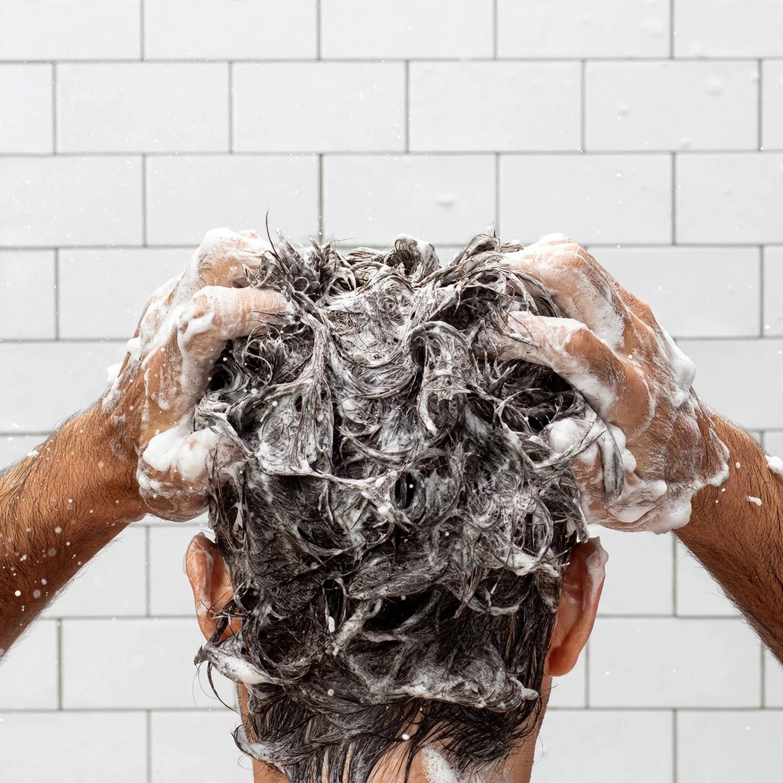 Foam and water covering hair during a wash.