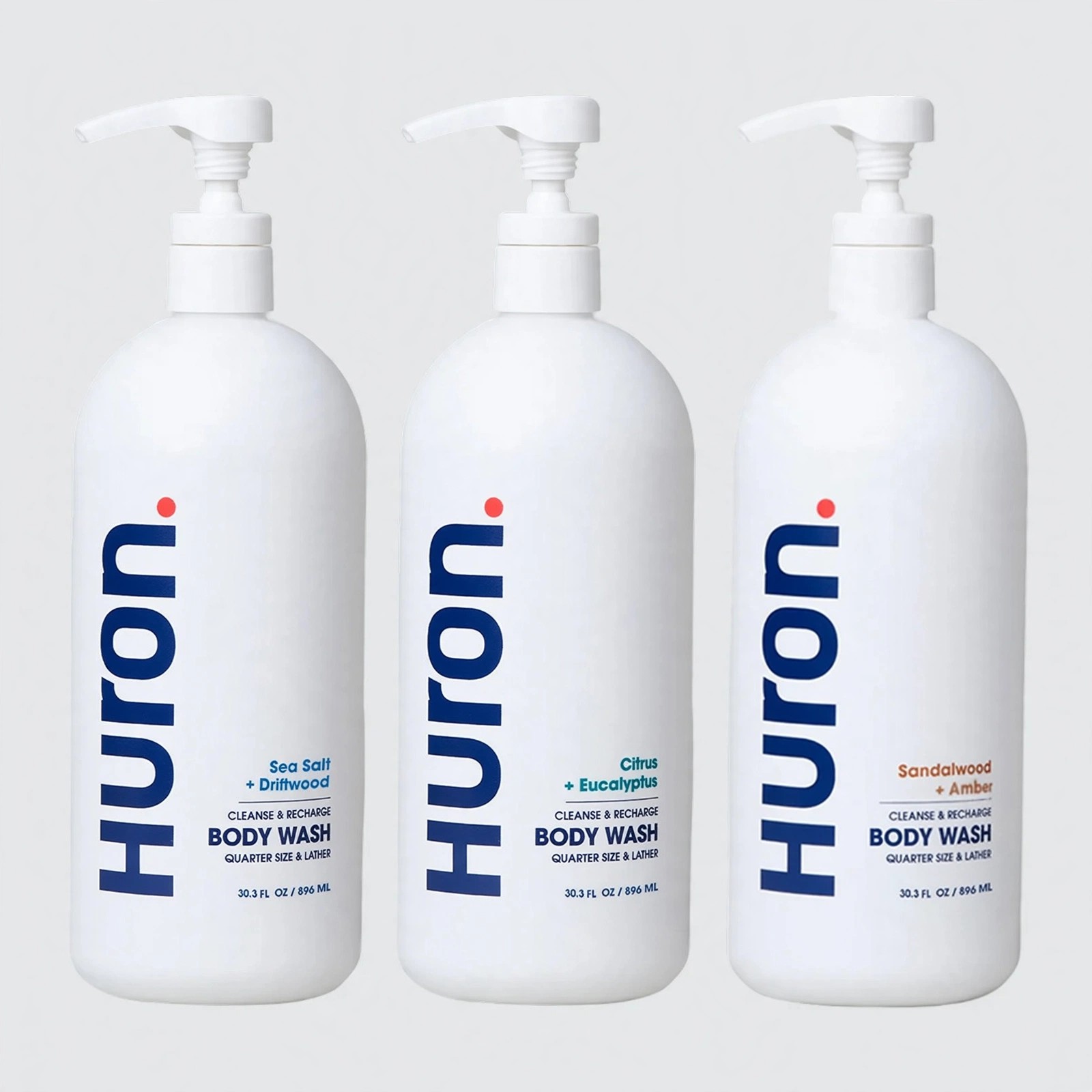 Three Huron Body Wash bottles in a row.