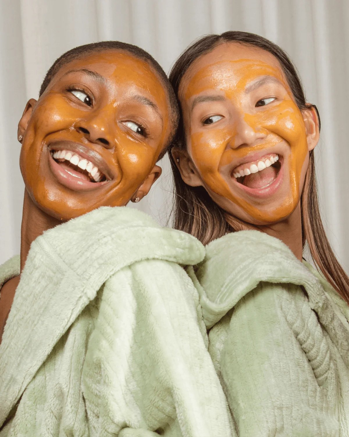 Pair of models poses with AHA mask applied.