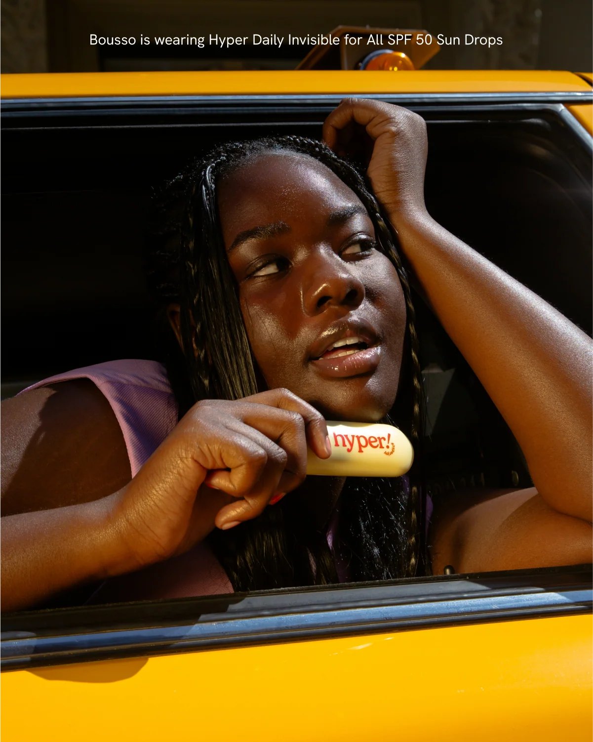Model poses in taxi window with Hyper SPF.